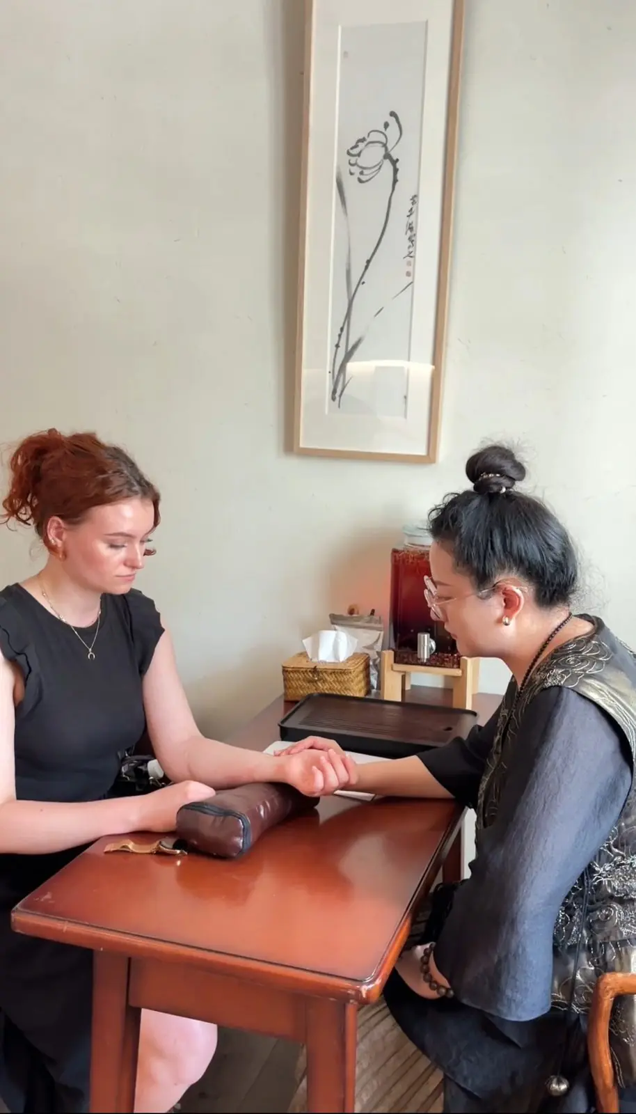 A guest and host at a table during a mind-restoration session in Shanghai